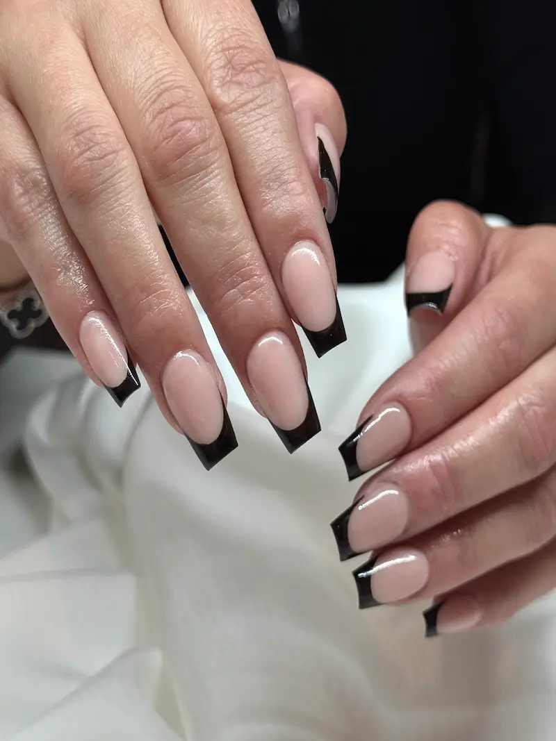 Modern black French manicure and chic nail art at our nail salon in Fribourg