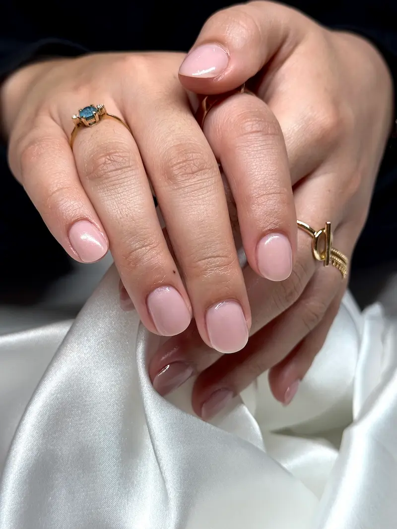 Natural nude nail design and clean manicure styling at our professional nail salon in Fribourg